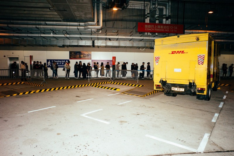 People lined up to buy high fashion clothing from a DHL truck in Hong Kong