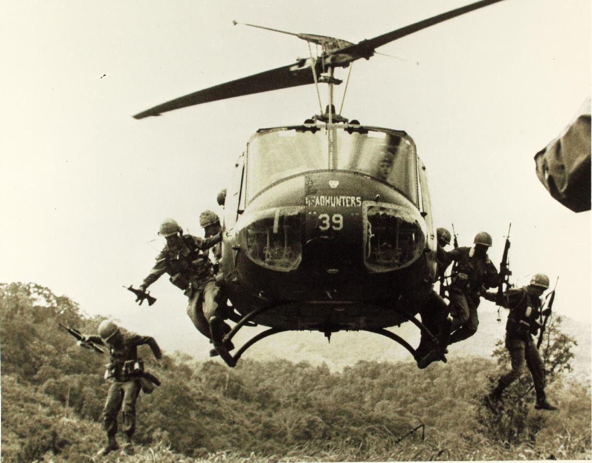 A photograph depicting soliders in a helicopter during the Vietnam War